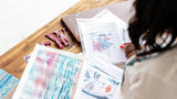 Emma Reid arranging her artworks